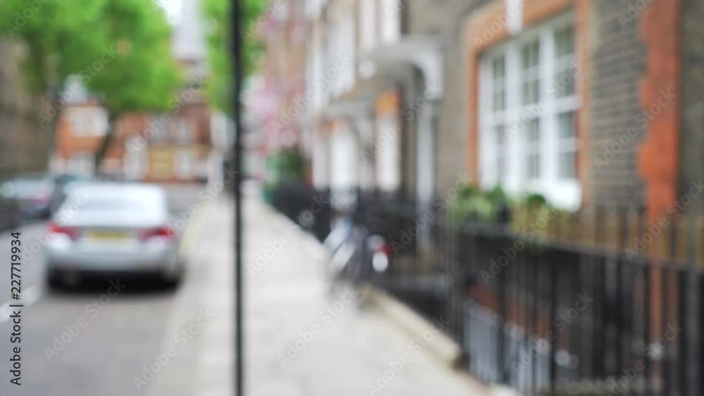 Defocused shot of row of pretty townhouses on quiet street in London, England Defocused shot of row of pretty townhouses on quiet street in London, England