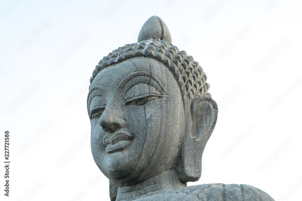 Buddha stone statue peaceful face isolated on white background Buddha stone statue peaceful face isolated on white background
