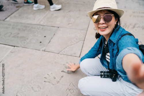 traveler taking selfie with palm sign on ground © PR Image Factory