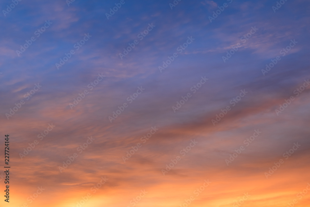 Sunset sky with curve cloud in blue and yellow color