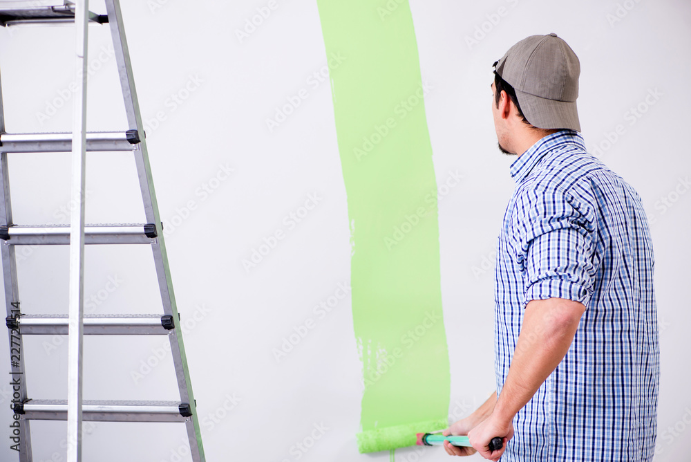 Young painter doing renovation at home Young painter doing renovation at home