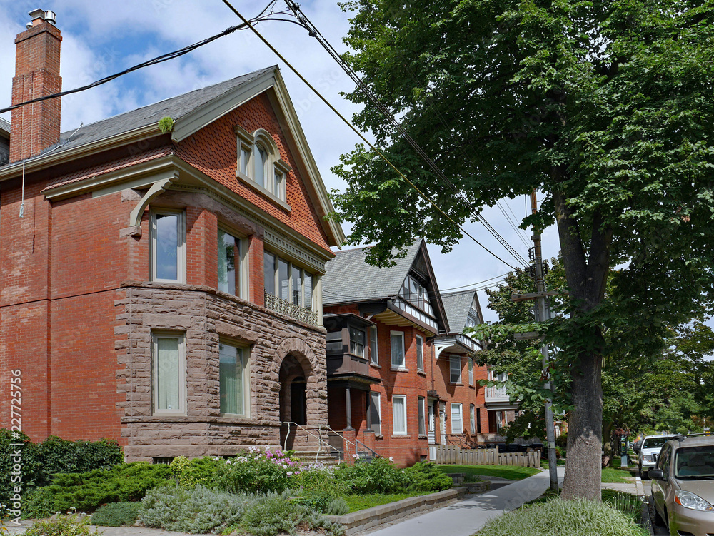 row of large old brick houses with gables