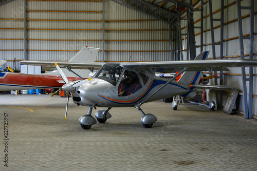 outdoor shot of small plane standing in shed