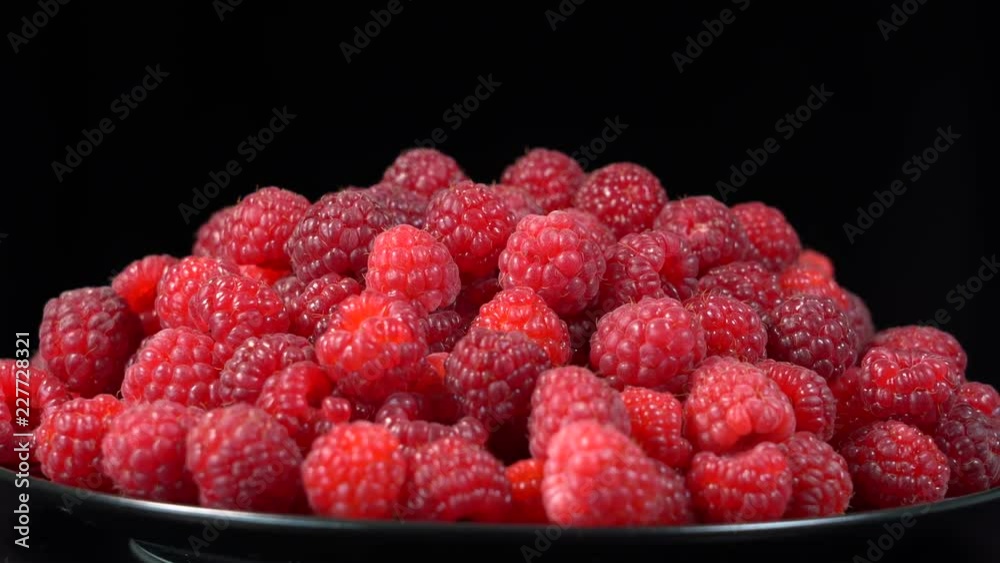 Fresh, ripe, juicy raspberry background, close up berry, rotation loopable 4k . Food background. Gastronomy concept, organic food. Macro red raspberries fruit in plate on black background Fresh, ripe, juicy raspberry background, close up berry, rotation loopable 4k . Food background. Gastronomy concept, organic food. Macro red raspberries fruit in plate on black background