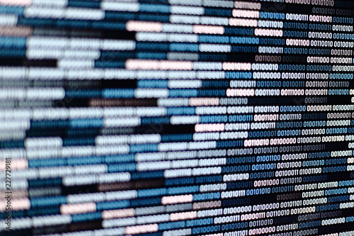 Big overload blockchain data. Blue binary data code background for internet and cyberspace security function. one and zero text on LED moniter screen.