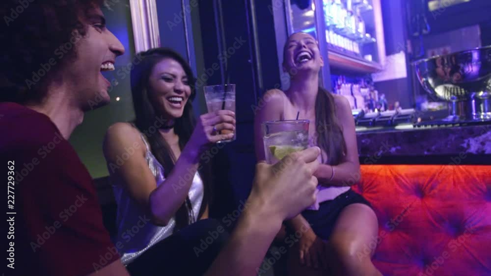 Group of friends having good time in nightclub party