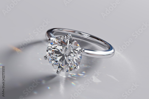 Round solitaire diamond engagement ring on white glossy background. 3D rendering