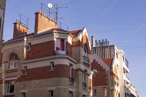 Roofs, facades, balconies and chimneys of buildings in Paris