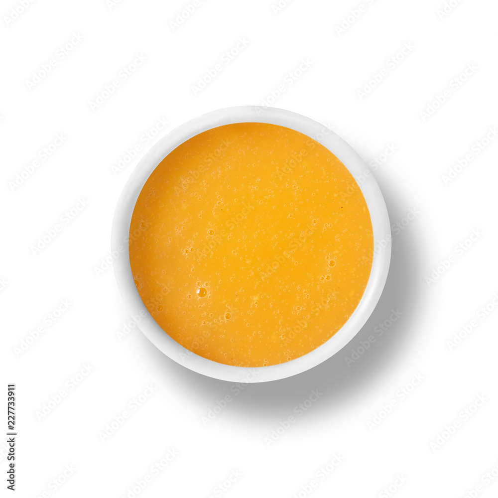 cup of orange dressing isolated on white, view from above cup of orange dressing isolated on white, view from above