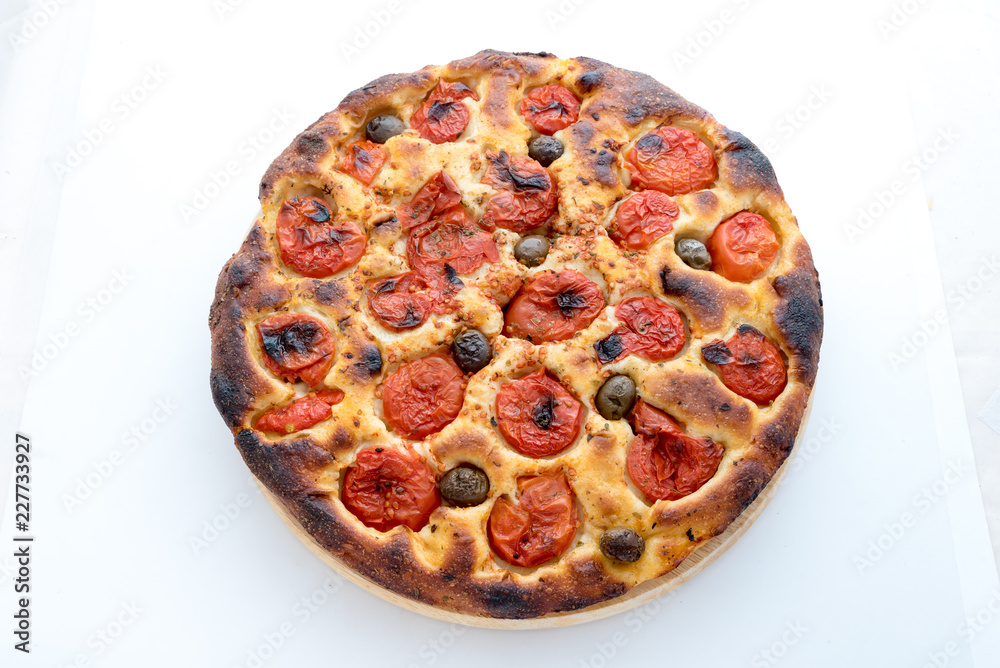 Focaccia typical of Bari Italy with tomatoes and olive