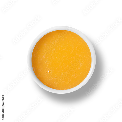 cup of orange dressing isolated on white, view from above