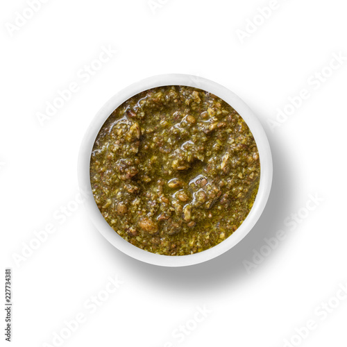 cup of pesto sauce isolated on white, view from above