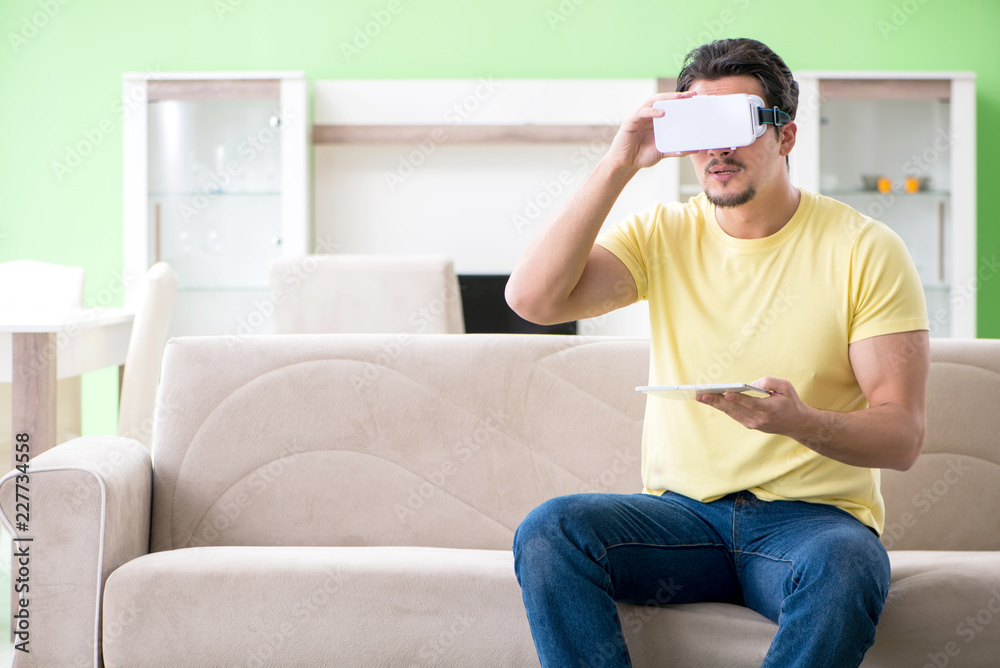 Fototapeta premium Young man with virtual reality goggles