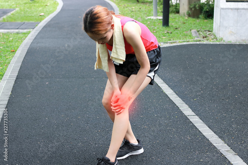 Fitness woman runner suffering from broken knee. Running injury accident concept.