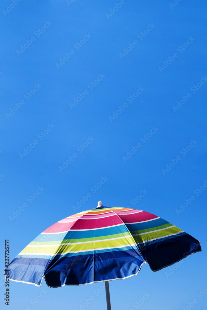 colorful umbrella on a background of blue sky
