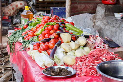 Stand with vegetables on display (Kashgar Animal Market, Xinjiang) photo
