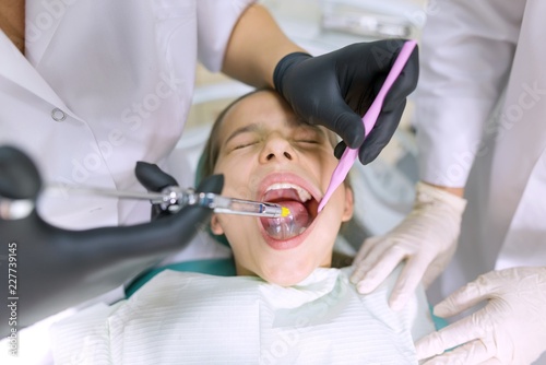 Young patient in dental chair. Medicine, dentistry and healthcare concept