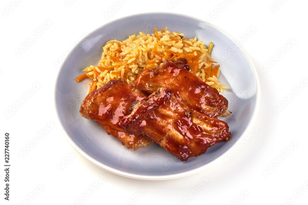 Delicious spicy marinated ribs in a bbq or tomato sauce with rice, isolated on a white background Delicious spicy marinated ribs in a bbq or tomato sauce with rice, isolated on a white background