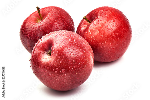 Shiny Red ripe apples with water drops, isolated on white background. Fresh raw organic fruits. Close-up.