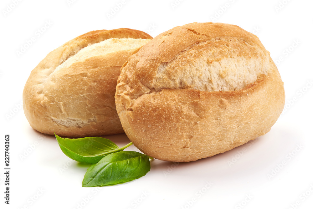 Freshly baked crispy bread rolls with basil leaves, close-up, isolated on a white background