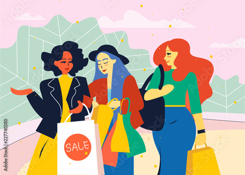 Female friends go from the store with shopping bags.