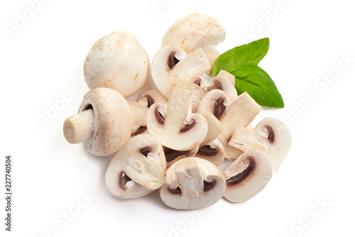 Delicious Sliced Sweden champignons with basil leaves, close-up, isolated on white background.