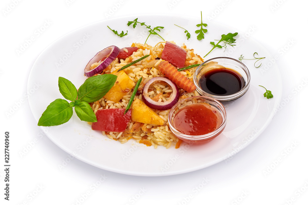 Fried mixed vegetables with rice and sauces, Chinese recipes WOK. Vegetarian food. Isolated on white background Fried mixed vegetables with rice and sauces, Chinese recipes WOK. Vegetarian food. Isolated on white background