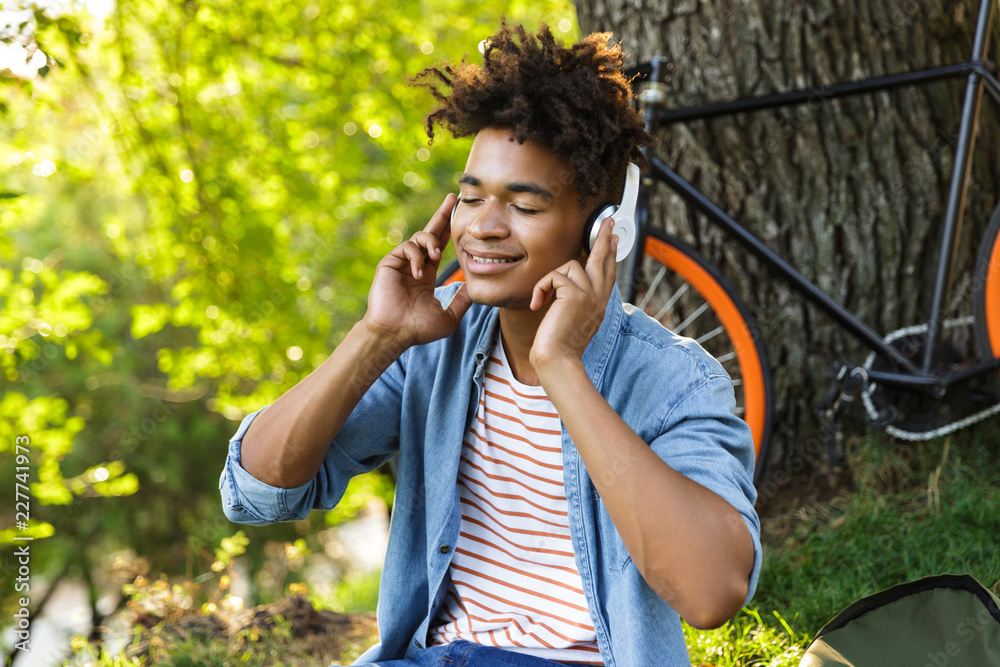 Cheerful young african teenager with backpack outdoors Cheerful young african teenager with backpack outdoors