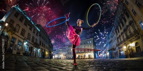 Night street circus performance whit clown, juggler. Festival city background. fireworks and Celebration atmosphere. Wide engle photo