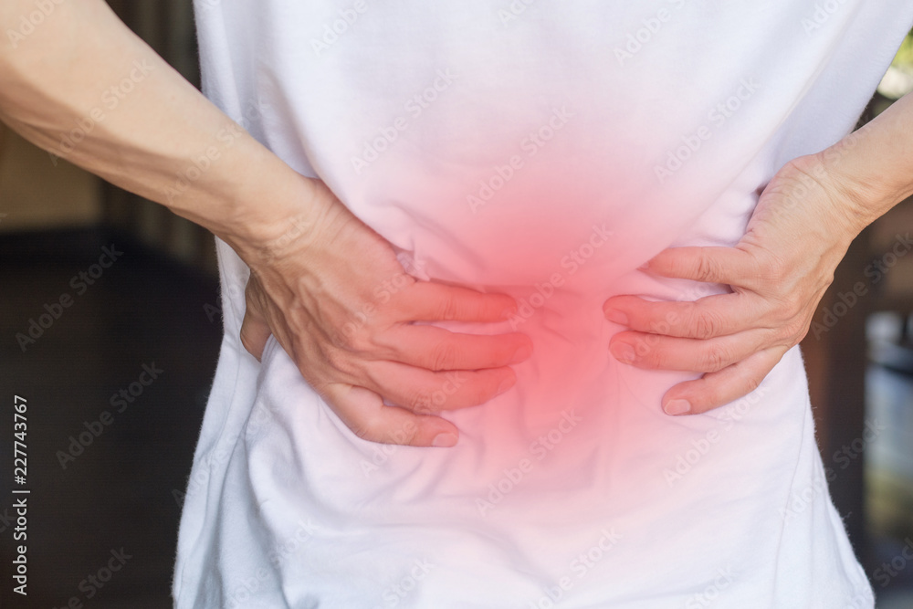 Man's hands on his back with red spot as suffering on backache. Male