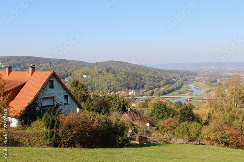 Landschaft im Herbst, weiter Blick auf die Stadt Vlotho (Nordrhein-Westfalen, Deutschland), die Weser und im Hintergrund das Wiehengebirge.  photo