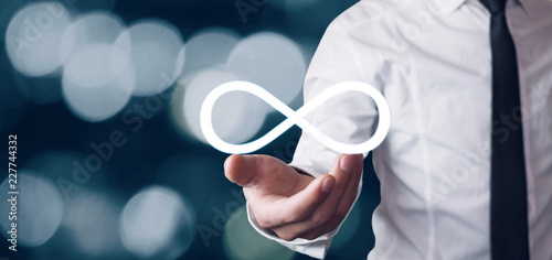 Fotografia Man holding Infinity symbol. Business concept