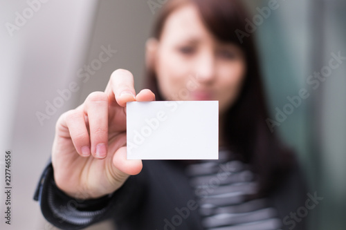 Hand holding business card with the message contact icons