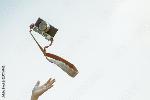 An old camera that floats on the air in stripe vintage.Old camera floating in the air