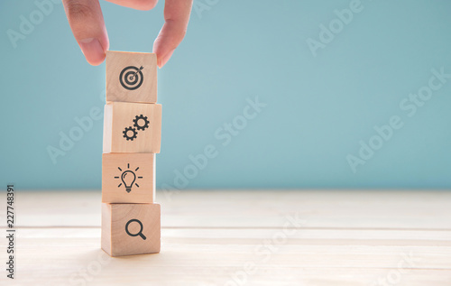 Businessman hand arranging wood block with icon business strategy and Action plan, copy space. photo