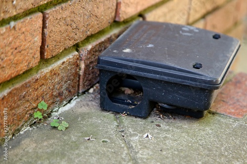 A black plastic rat trap (baiting box). Pest control concept image. 