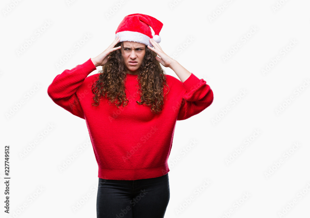 Young brunette girl wearing christmas hat over isolated background suffering from headache desperate and stressed because pain and migraine. Hands on head. Young brunette girl wearing christmas hat over isolated background suffering from headache desperate and stressed because pain and migraine. Hands on head.