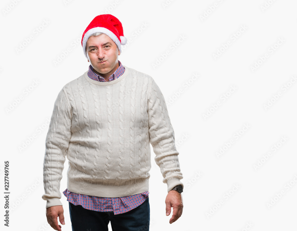 Handsome senior man wearing christmas hat over isolated background puffing cheeks with funny face. Mouth inflated with air, crazy expression. Handsome senior man wearing christmas hat over isolated background puffing cheeks with funny face. Mouth inflated with air, crazy expression.