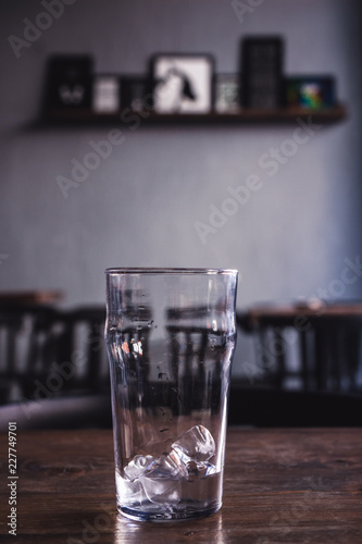Ice Cubes in Glass on Wooden Table in Coffee Shop