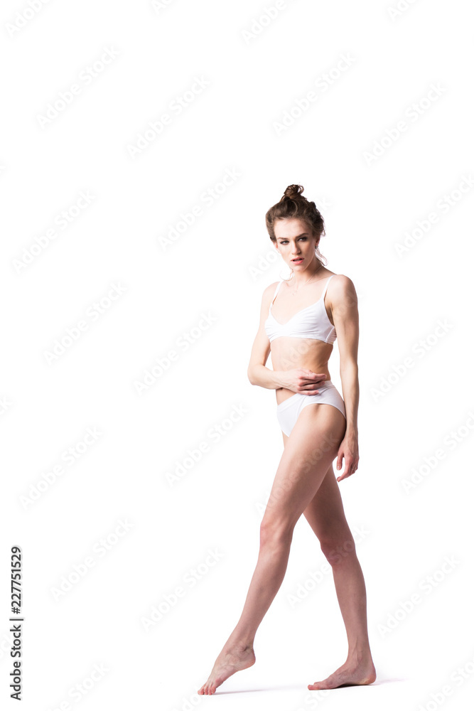 Female with a good figure in white underwear posing. Isolated. Female with a good figure in white underwear posing. Isolated.
