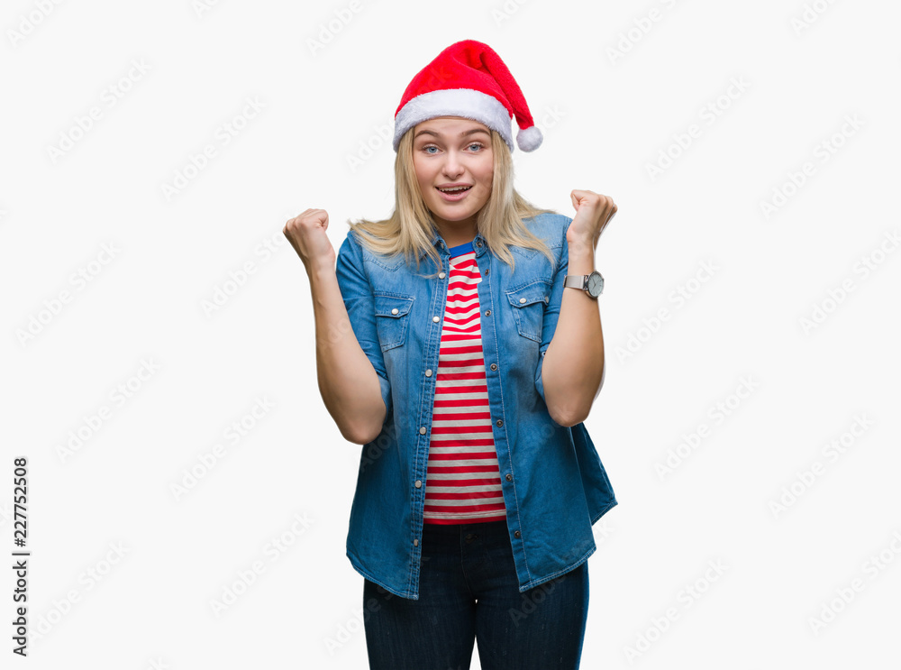 Young caucasian woman wearing christmas hat over isolated background celebrating surprised and amazed for success with arms raised and open eyes. Winner concept. Young caucasian woman wearing christmas hat over isolated background celebrating surprised and amazed for success with arms raised and open eyes. Winner concept.