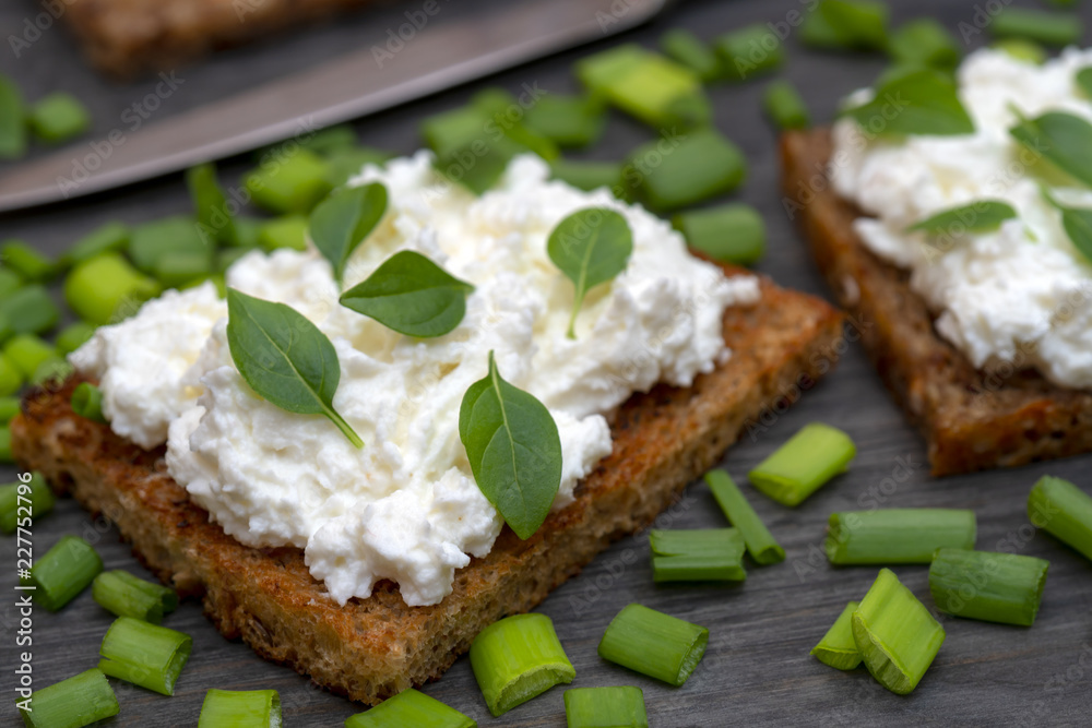 Whole grain bread with feta cheese and herbs.
