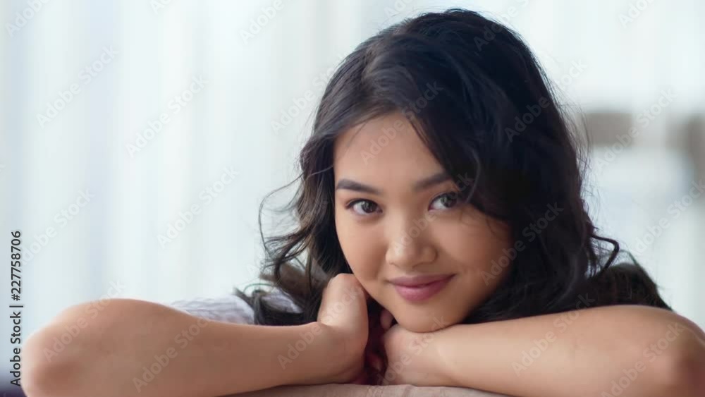 Attractive smiling Asian young woman flirting and relaxing close-up portrait Attractive smiling Asian young woman flirting and relaxing close-up portrait