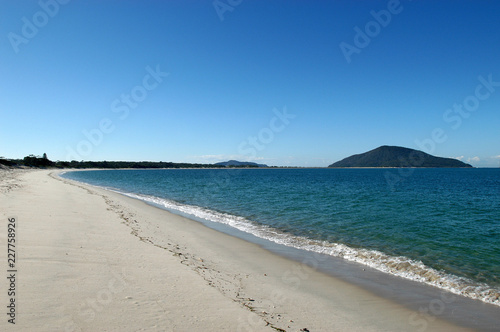 Small breaking waves on a deserted beach