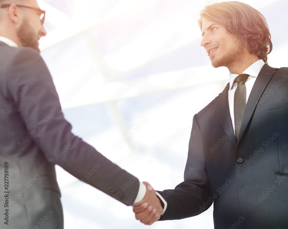 Business handshake and business people. Business handshake and business people.
