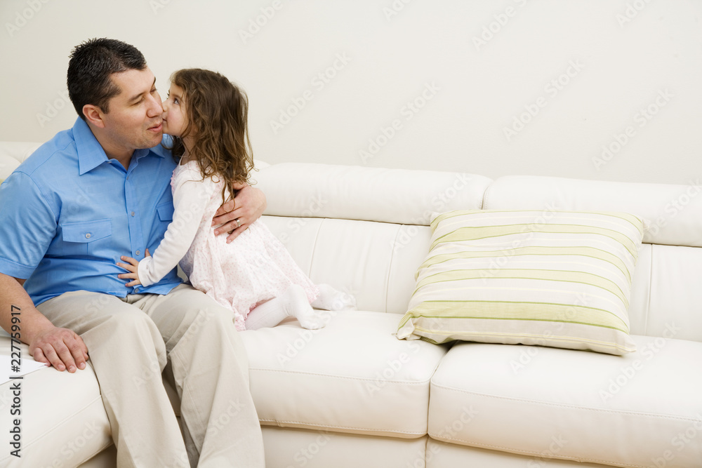 young couple sitting on sofa at home