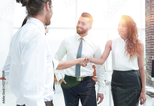 business women greet each other with a handshake