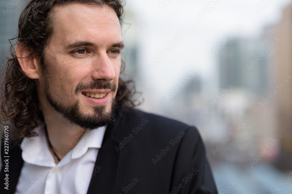 Fototapeta premium Handsome businessman against view of the city in Bangkok, Thaila