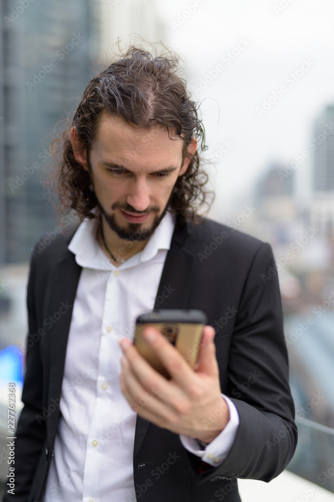 Handsome businessman against view of the city in Bangkok, Thaila Handsome businessman against view of the city in Bangkok, Thaila