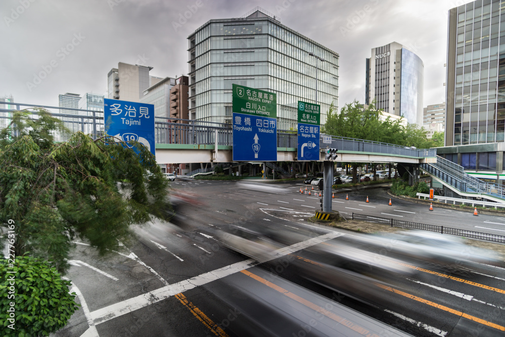 Blurred cars are passing through junction in Downtown Nagoya, Japan